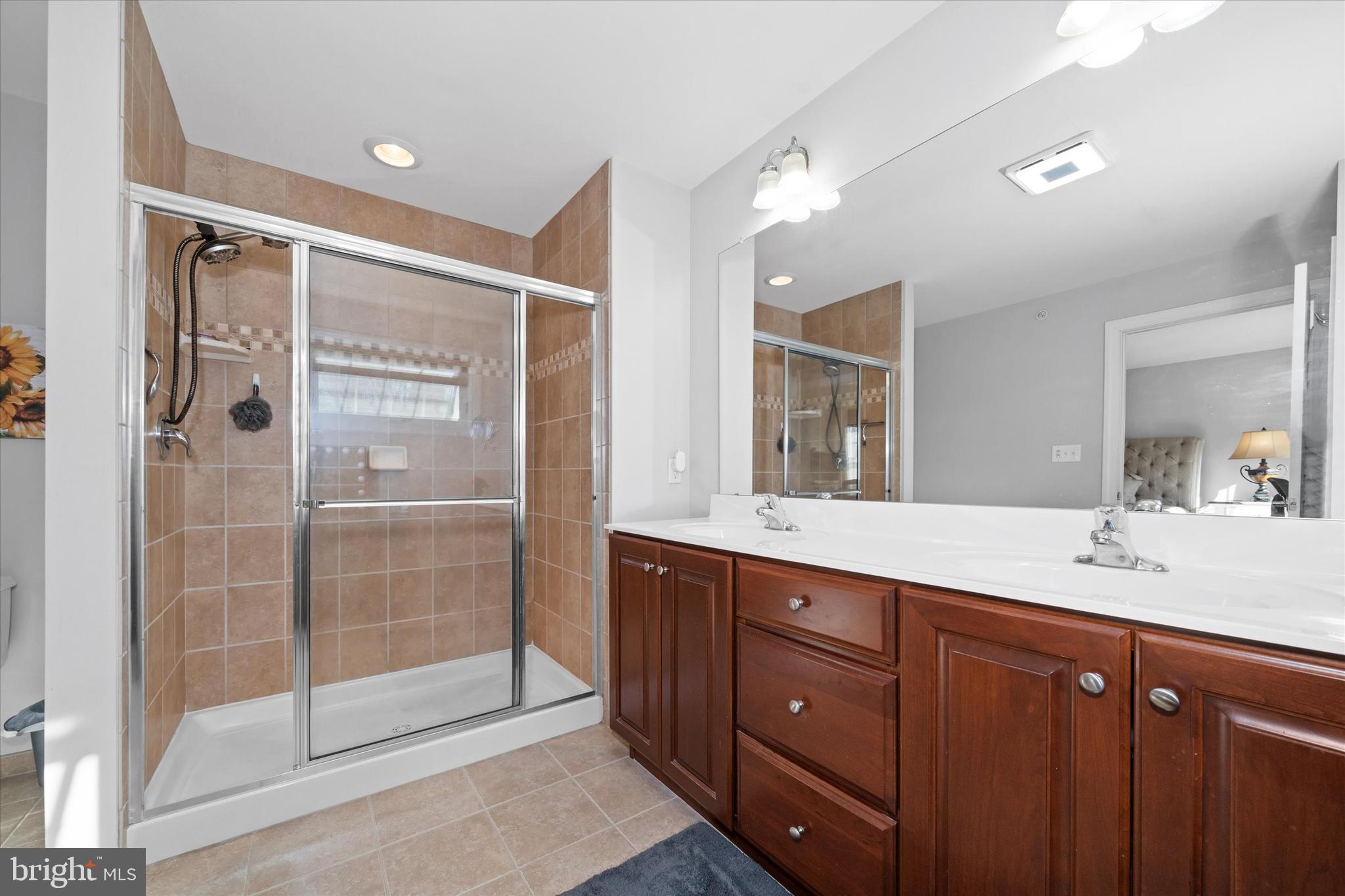 264 Deepdale Drive, Unit 31 Kennett Square, PA 19348 - Photo 17 of 34 a bathroom with a shower sink and mirror
