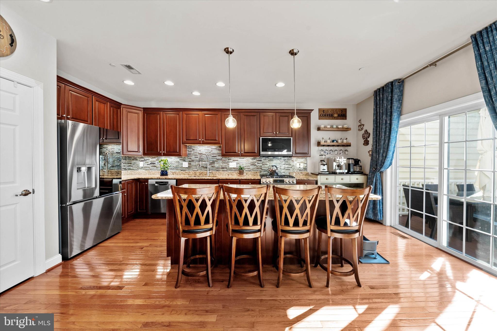 264 Deepdale Drive, Unit 31 Kennett Square, PA 19348 - Photo 8 of 34 a kitchen with stainless steel appliances granite countertop a table chairs sink refrigerator and cabinets