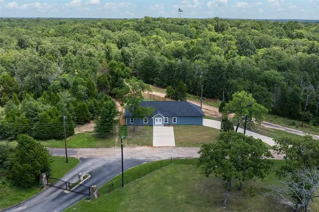 a view of a house with a yard and tree s