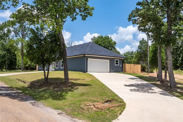 a house that has a tree in front of it