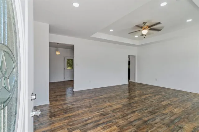 wooden floor in an empty room with a window