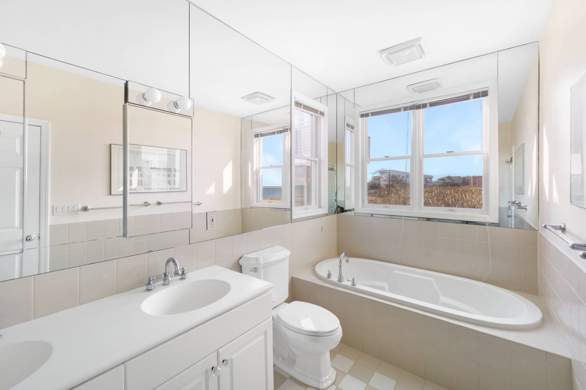 580 Dune Road, Unit 3 Westhampton Beach, NY 11978 - Photo 11 of 19 a bathroom with a sink mirror toilet and bathtub