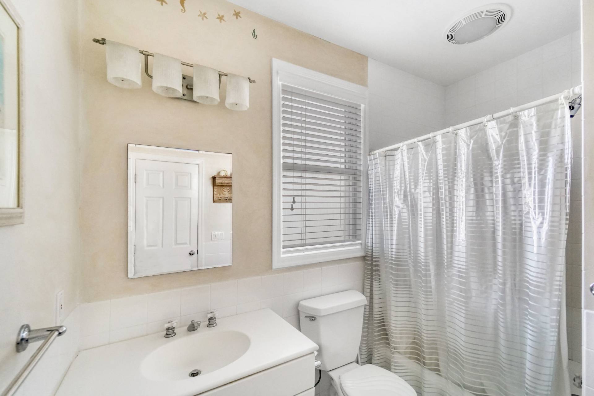 580 Dune Road, Unit 3 Westhampton Beach, NY 11978 - Photo 14 of 19 a bathroom with a sink a toilet and shower curtain