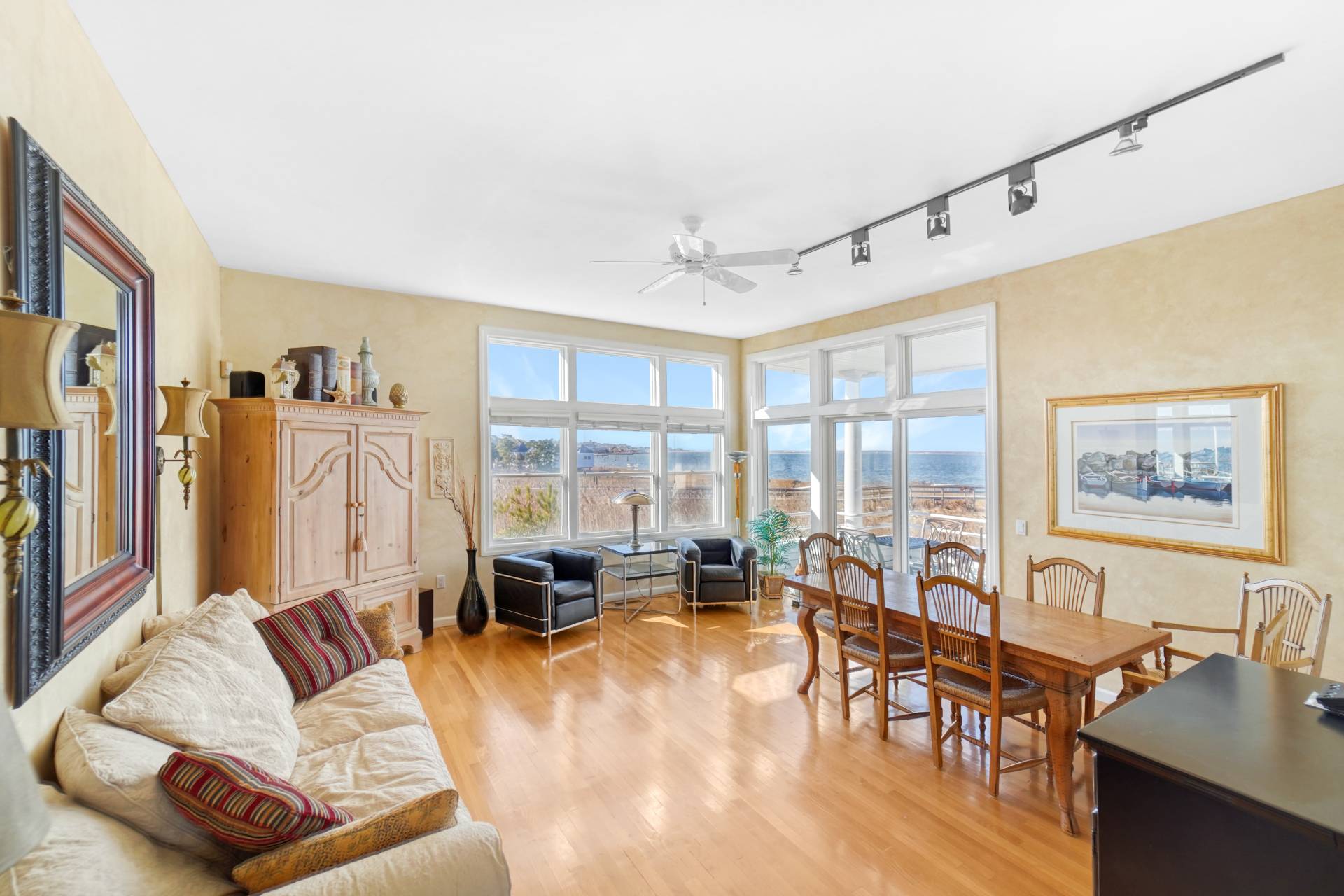 580 Dune Road, Unit 3 Westhampton Beach, NY 11978 - Photo 2 of 19 a living room with furniture and a large window