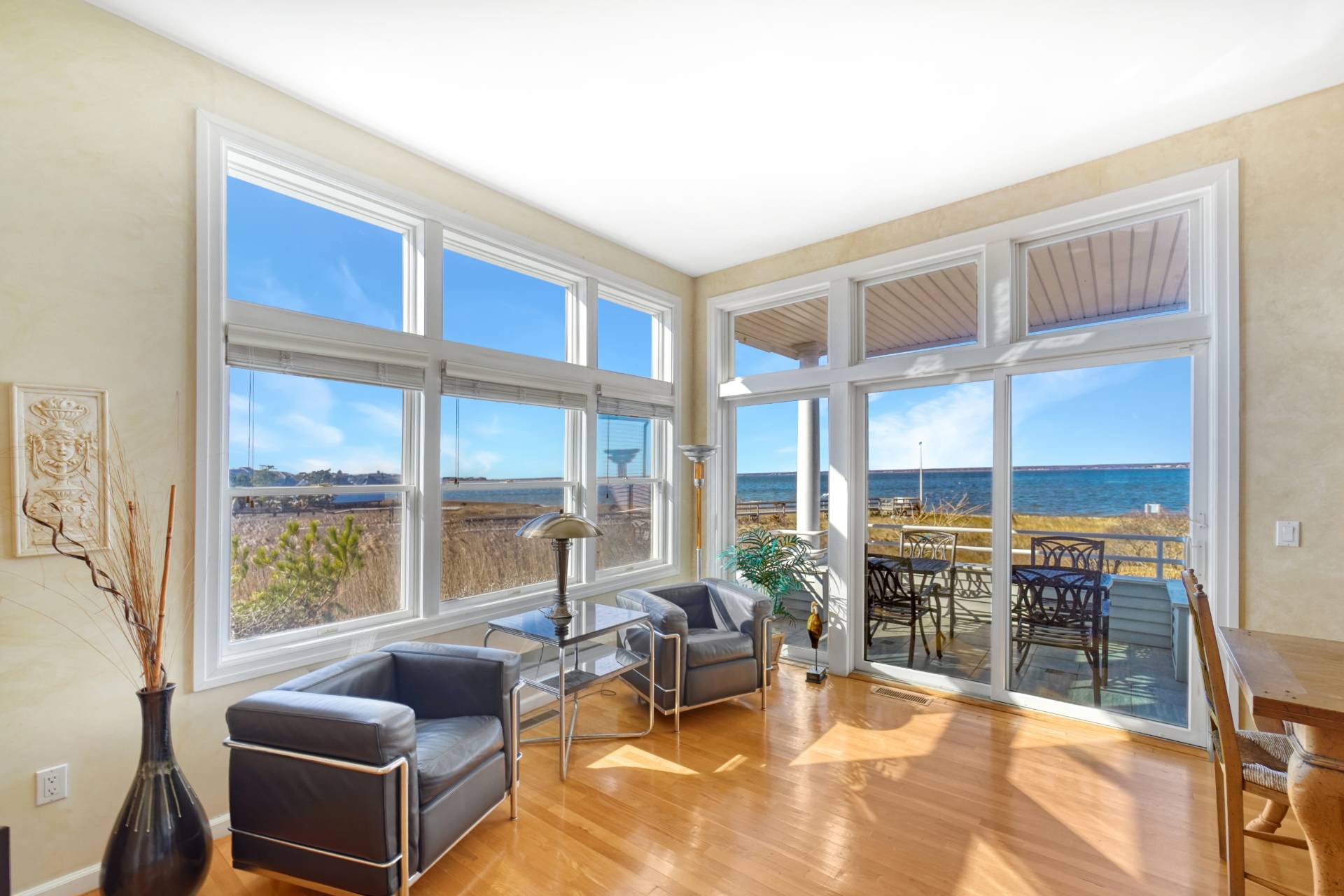 580 Dune Road, Unit 3 Westhampton Beach, NY 11978 - Photo 5 of 19 a living room with furniture tv and floor to ceiling window