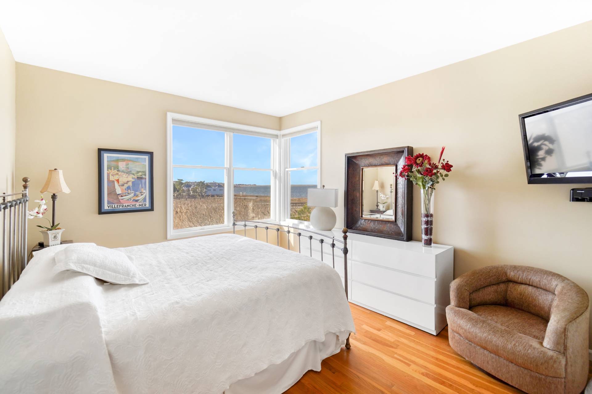 580 Dune Road, Unit 3 Westhampton Beach, NY 11978 - Photo 10 of 19 a bedroom with furniture and a large window