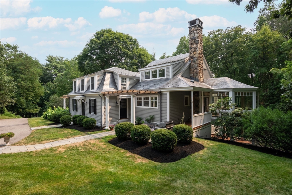 32 Intervale Road Weston, MA 02493 - Photo 2 of 42 a front view of a house with a yard and potted plants