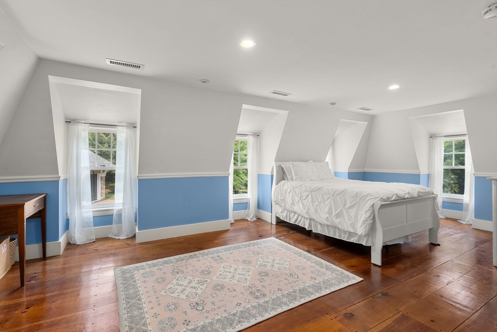 32 Intervale Road Weston, MA 02493 - Photo 25 of 42 a bedroom with a large bed and a fireplace