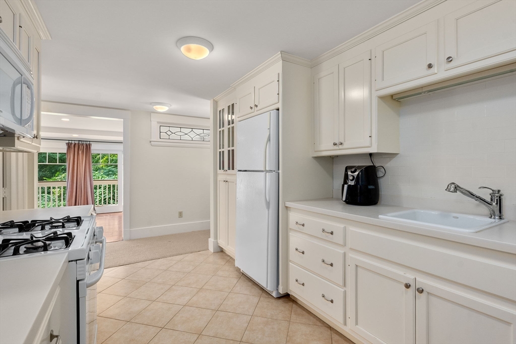 32 Intervale Road Weston, MA 02493 - Photo 30 of 42 a kitchen with white cabinets and refrigerator