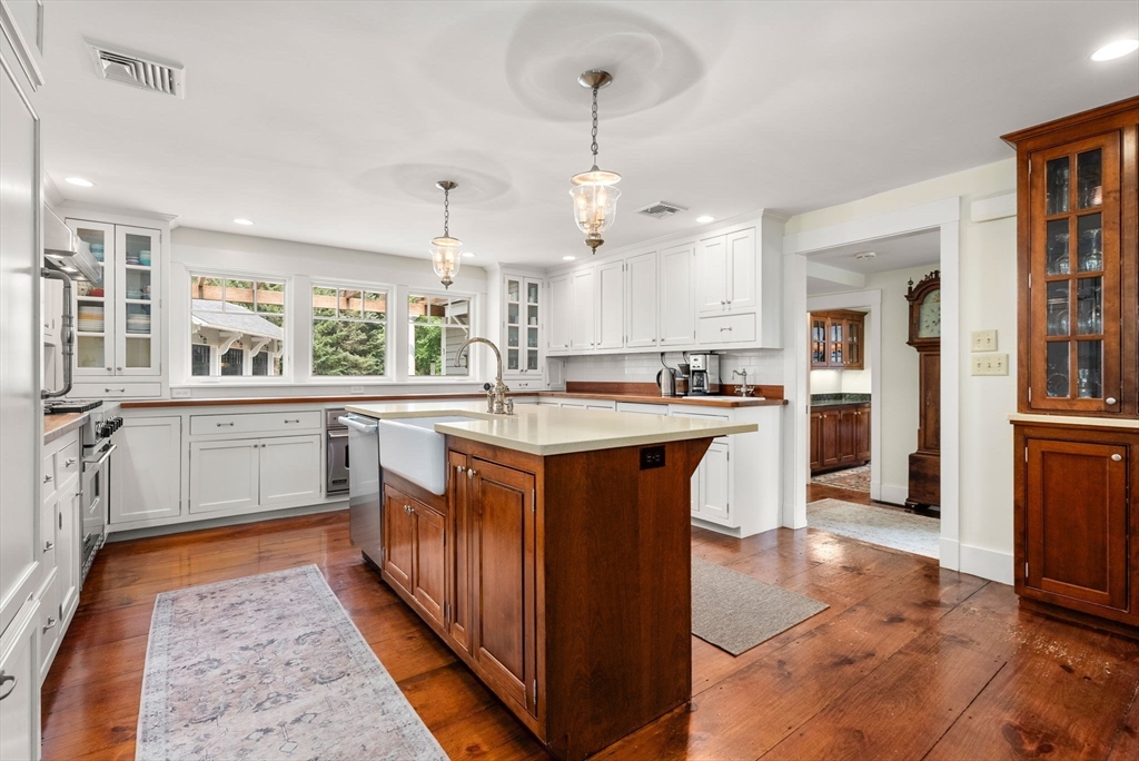32 Intervale Road Weston, MA 02493 - Photo 7 of 42 a kitchen with kitchen island granite countertop a sink appliances and cabinets