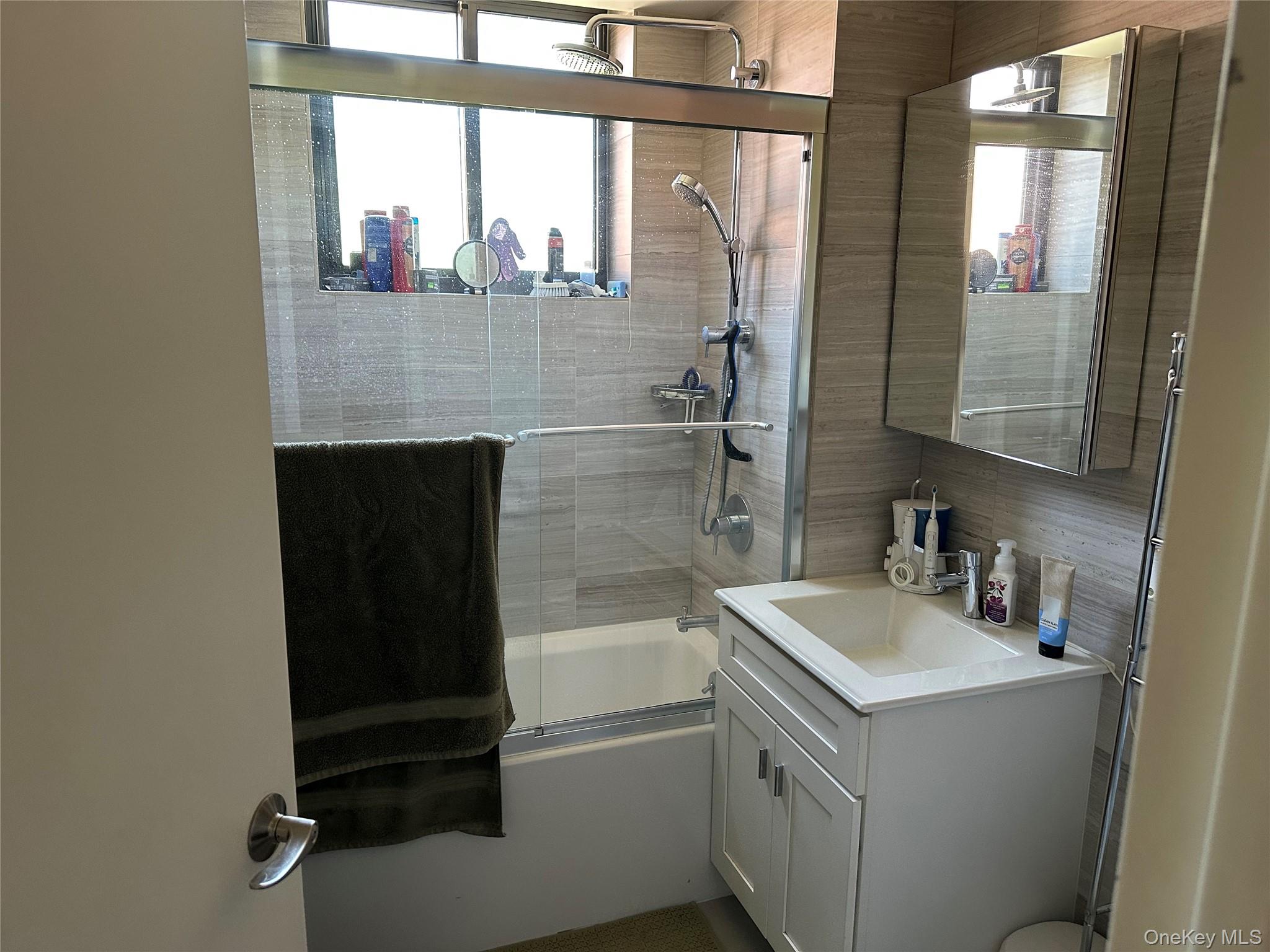 87-22 51st Avenue, Unit 4E Queens, NY 11373 - Photo 13 of 15 a bathroom with a sink and a bathtub
