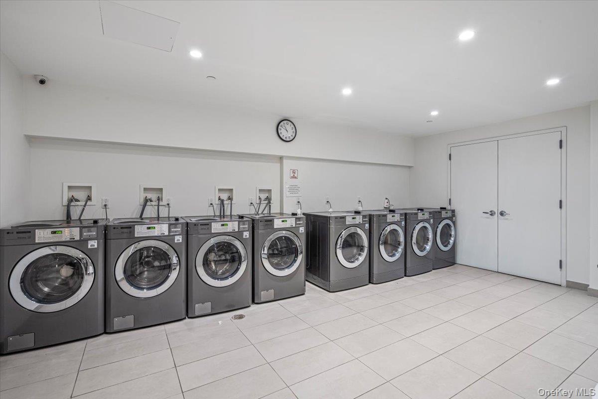 87-22 51st Avenue, Unit 4E Queens, NY 11373 - Photo 5 of 15 a view of a storage & utility room with washer and dryer