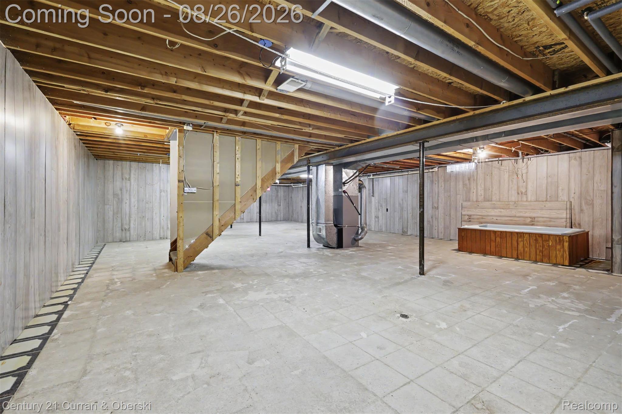 18227 Meridian Road Grosse Ile, MI 48138 - Photo 17 of 23 Expansive unfinished basement featuring exposed ceiling joists, concrete flooring, and support beams