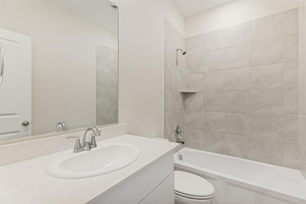 1237 Almond Road Azle, TX 76020 - Photo 20 of 24 a bathroom with a toilet a sink and bathtub