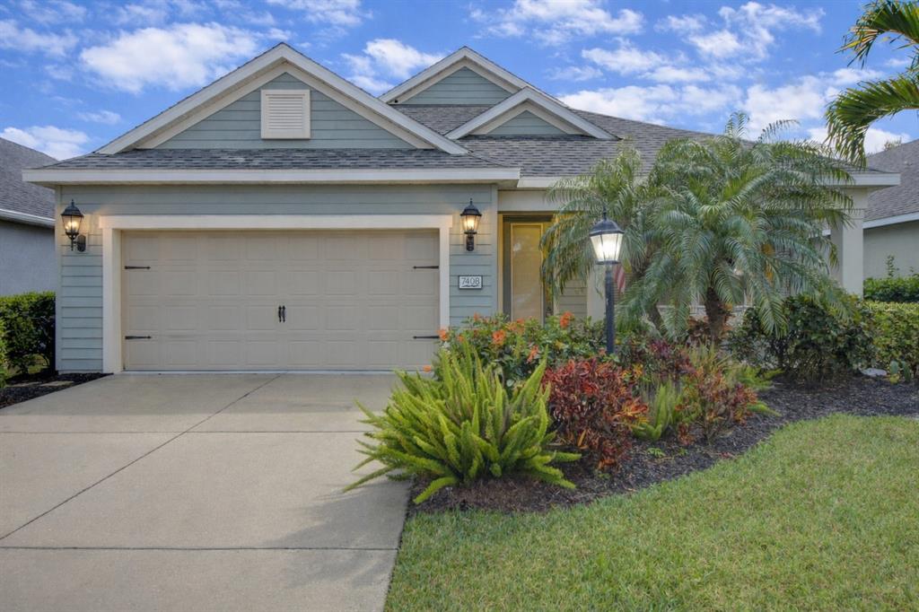 7408 Ridgelake Circle Bradenton, FL 34203 - Photo 1 of 39 a front view of a house with a garden