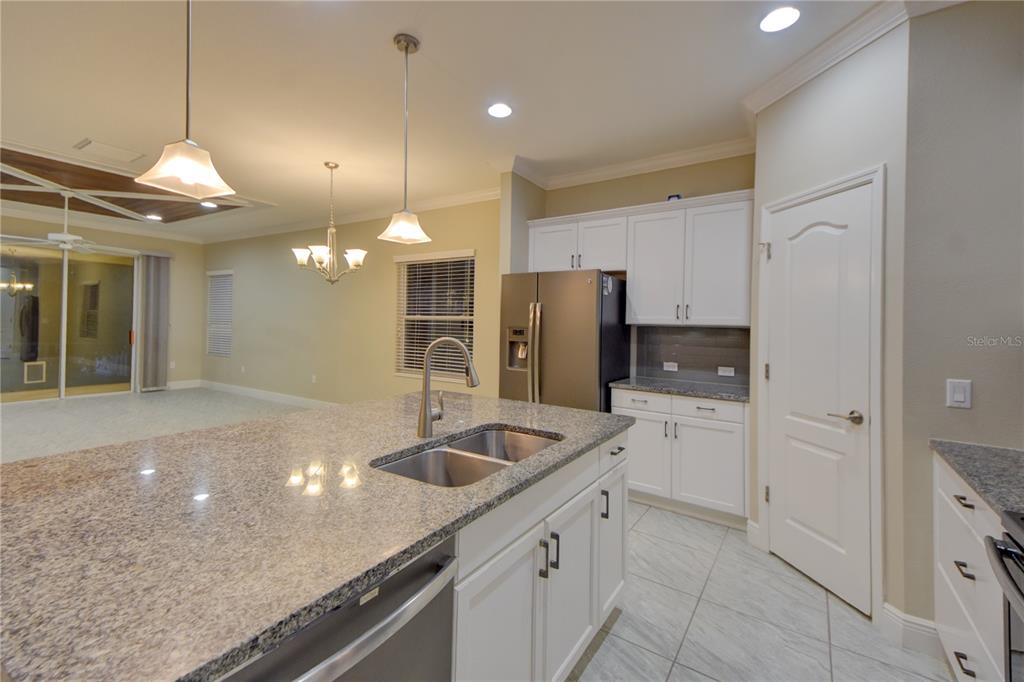 7408 Ridgelake Circle Bradenton, FL 34203 - Photo 15 of 39 a kitchen with stainless steel appliances granite countertop a sink and refrigerator