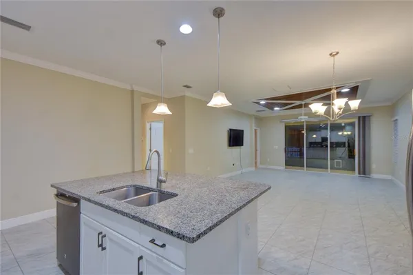 a kitchen with stainless steel appliances granite countertop a sink and a refrigerator