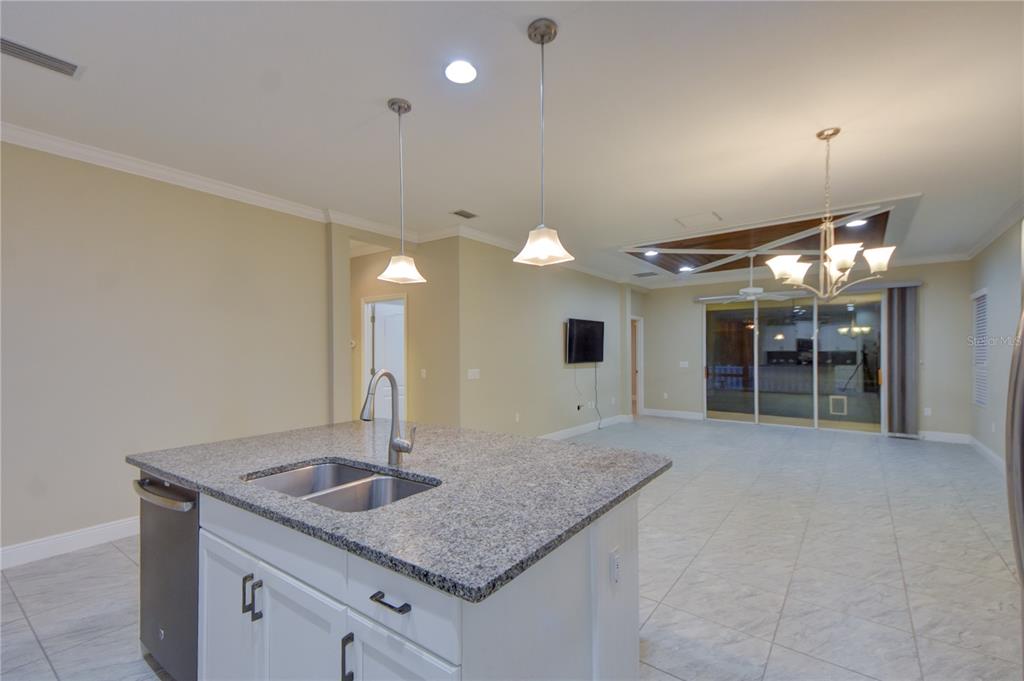 7408 Ridgelake Circle Bradenton, FL 34203 - Photo 16 of 39 a kitchen with stainless steel appliances granite countertop a sink and a refrigerator