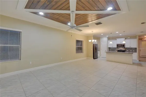 a view of an empty room with a kitchen