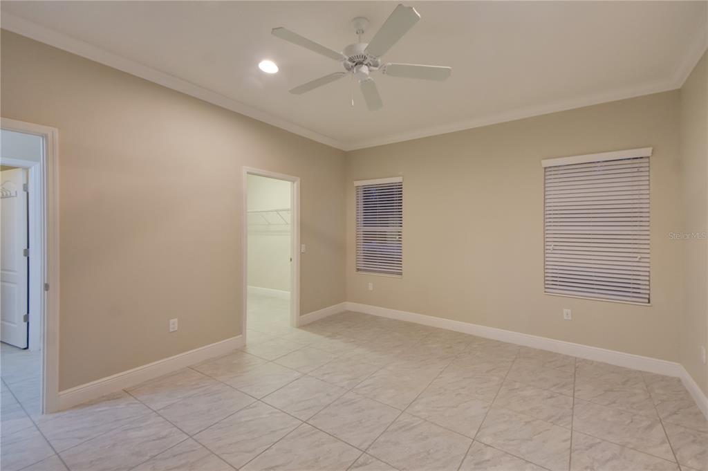 7408 Ridgelake Circle Bradenton, FL 34203 - Photo 25 of 39 an empty room with windows and fan