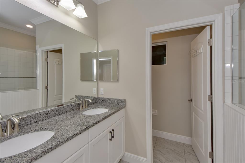 7408 Ridgelake Circle Bradenton, FL 34203 - Photo 28 of 39 a bathroom with a granite countertop sink and a mirror