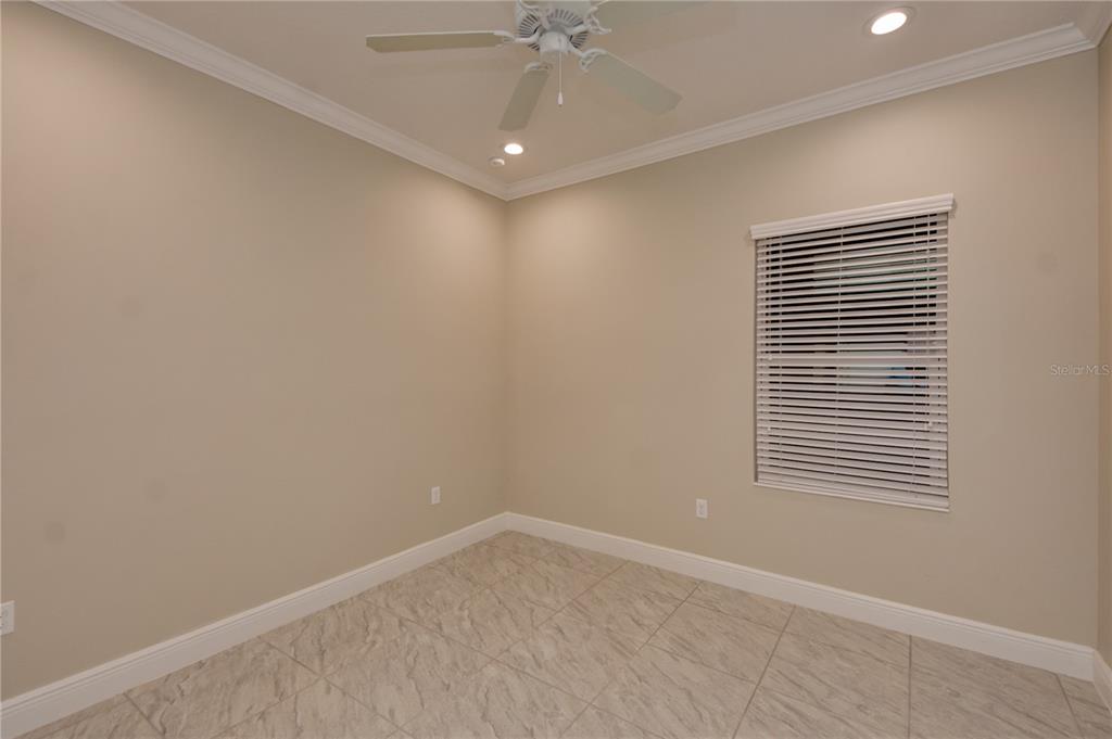 7408 Ridgelake Circle Bradenton, FL 34203 - Photo 32 of 39 an empty room with a window and a fan