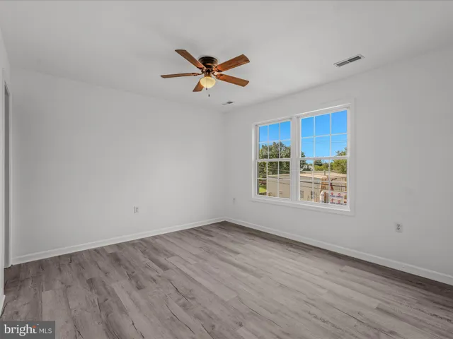 a view of a room with wooden floor and window