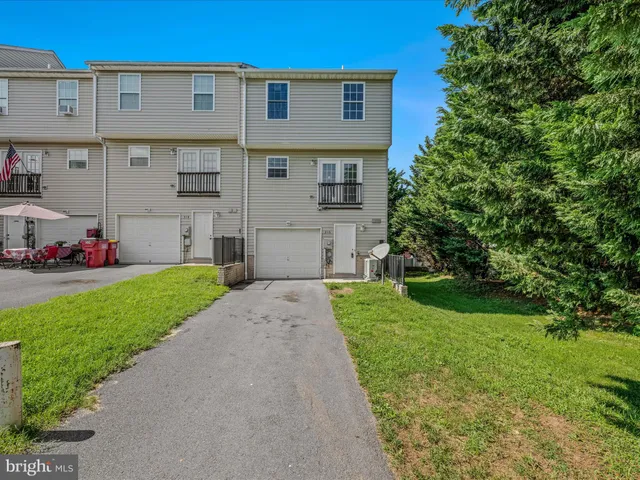 a front view of a house with a garden and yard