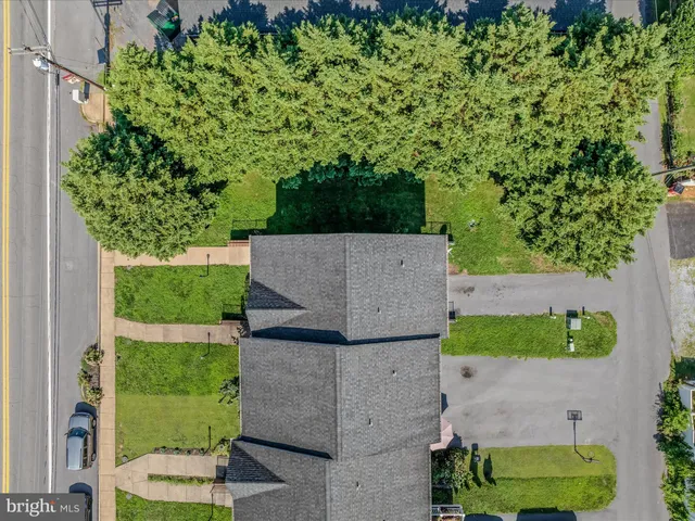 an aerial view of a house with a yard