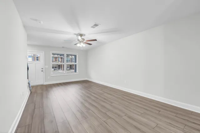 wooden floor in an empty room with a window