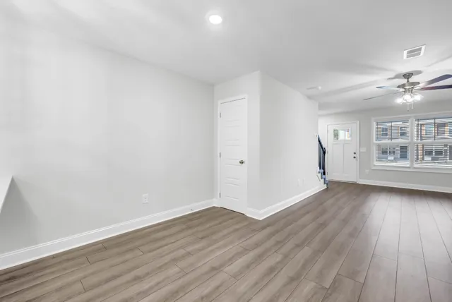 wooden floor in an empty room with a window