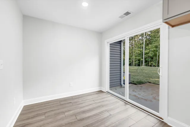 a view of wooden floor and window in a room