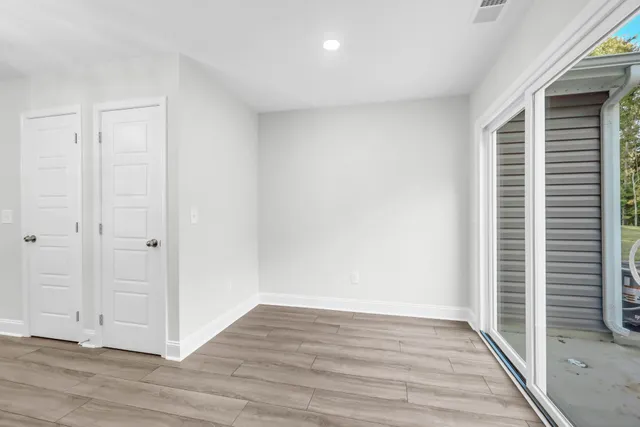 a view of wooden floor and windows in a room
