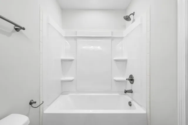 a bathroom with a bathtub and a shower