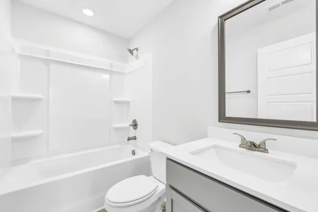 a bathroom with a sink toilet vanity and shower