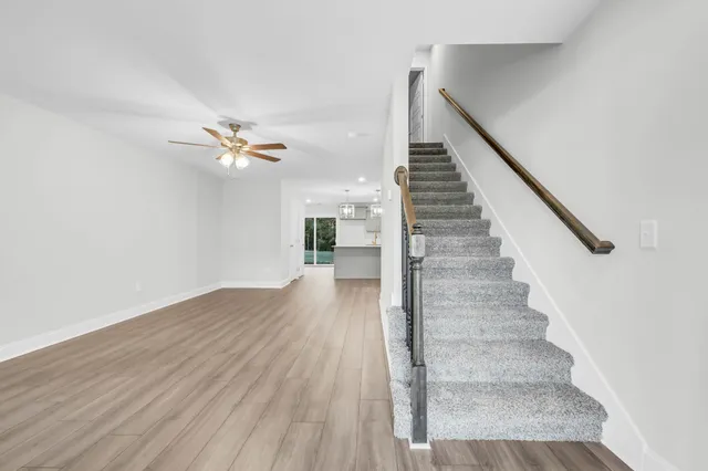 a view of entryway and hall with wooden floor