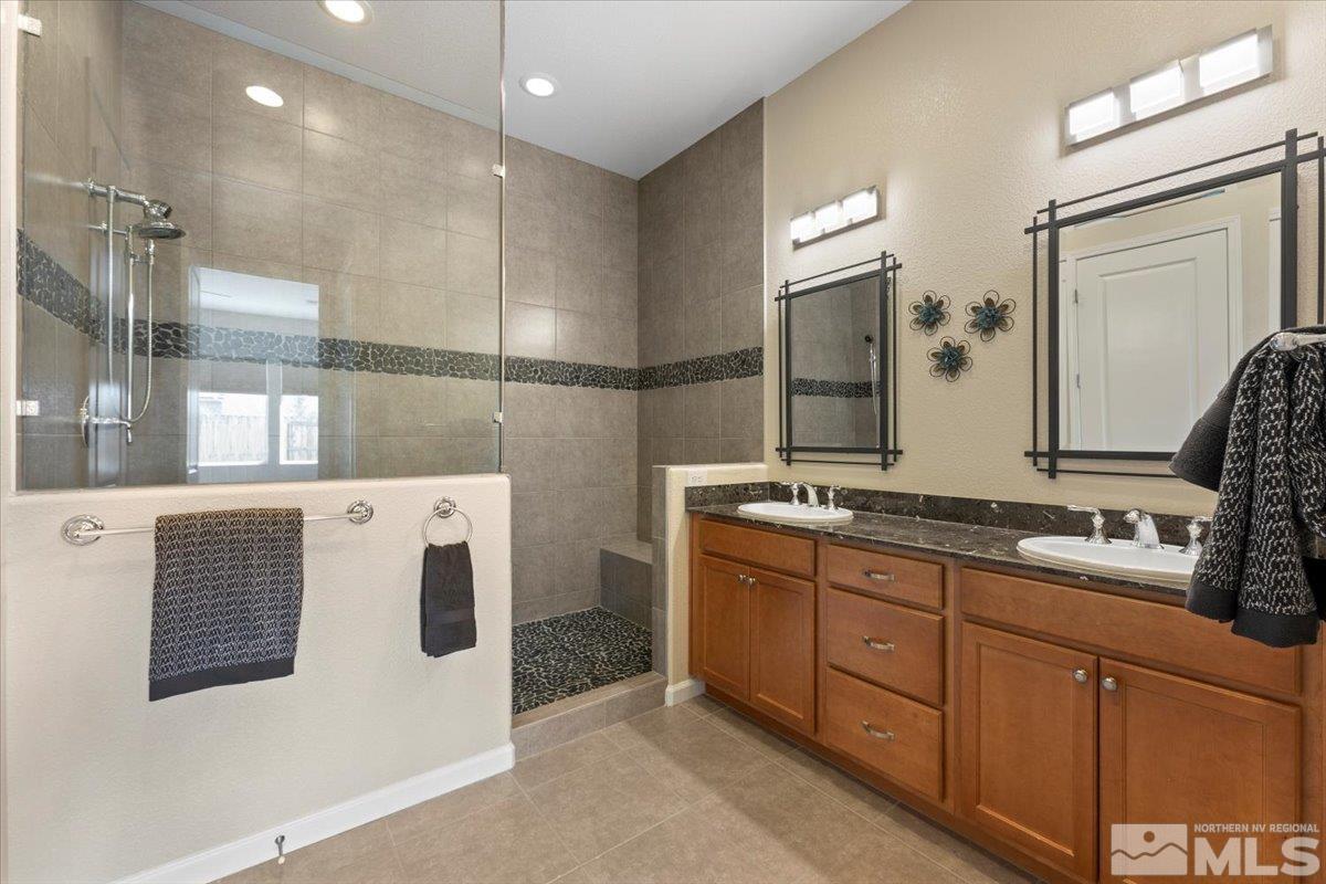 2300 Arpagos Lane Reno, NV 89521 - Photo 17 of 40 a bathroom with a double vanity sink and mirror