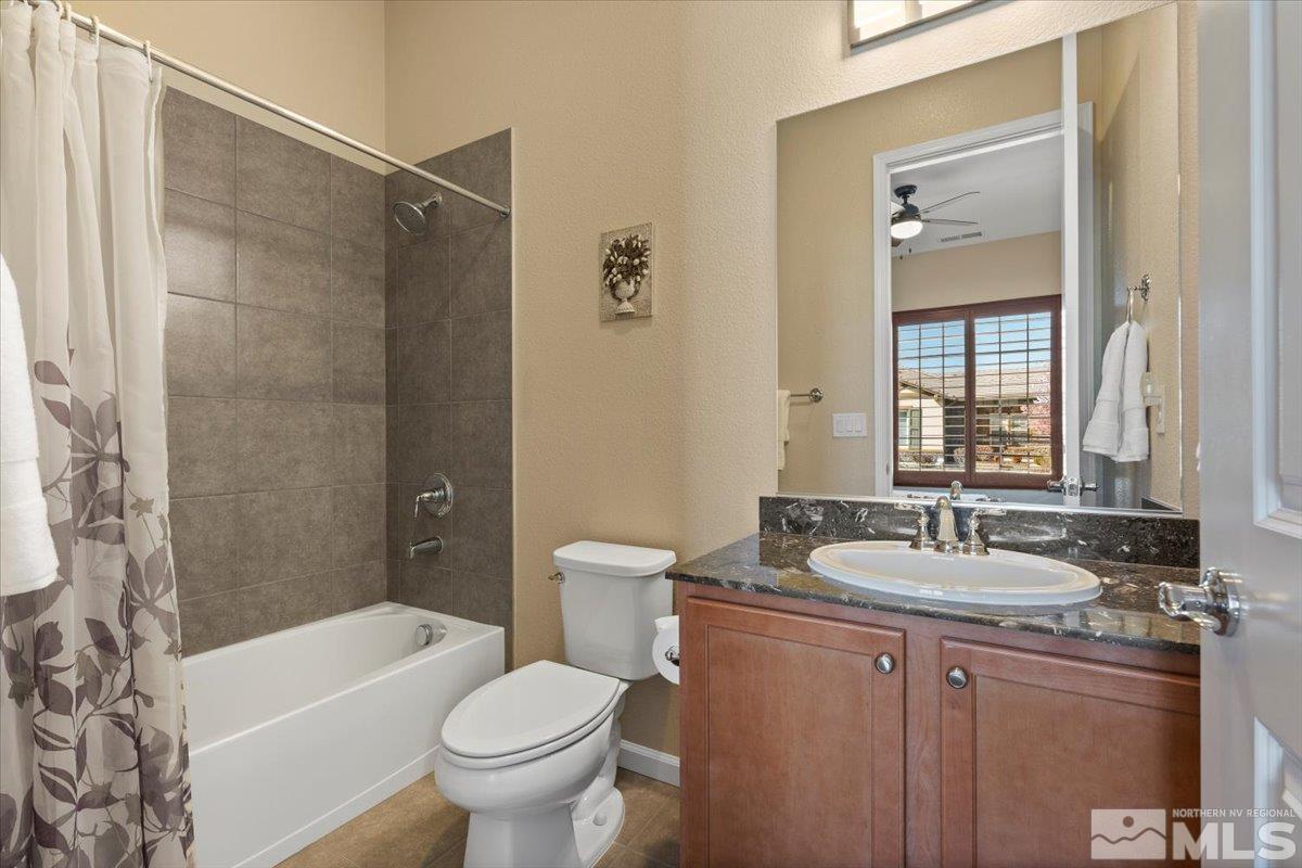 2300 Arpagos Lane Reno, NV 89521 - Photo 21 of 40 a bathroom with a granite countertop sink a toilet and shower