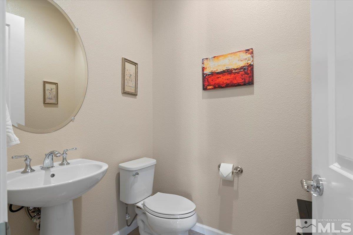 2300 Arpagos Lane Reno, NV 89521 - Photo 23 of 40 a bathroom with a toilet a sink and mirror