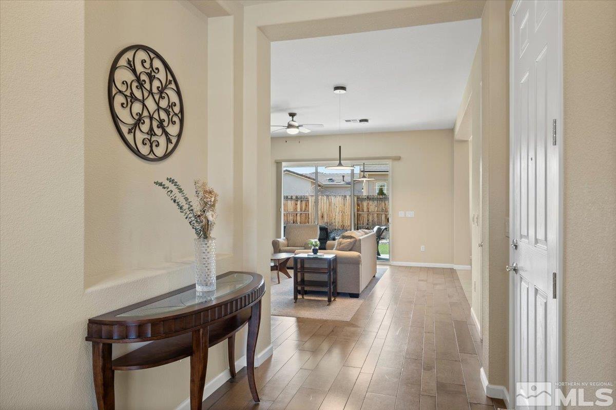2300 Arpagos Lane Reno, NV 89521 - Photo 5 of 40 a view of a livingroom with furniture a chandelier and wooden floor