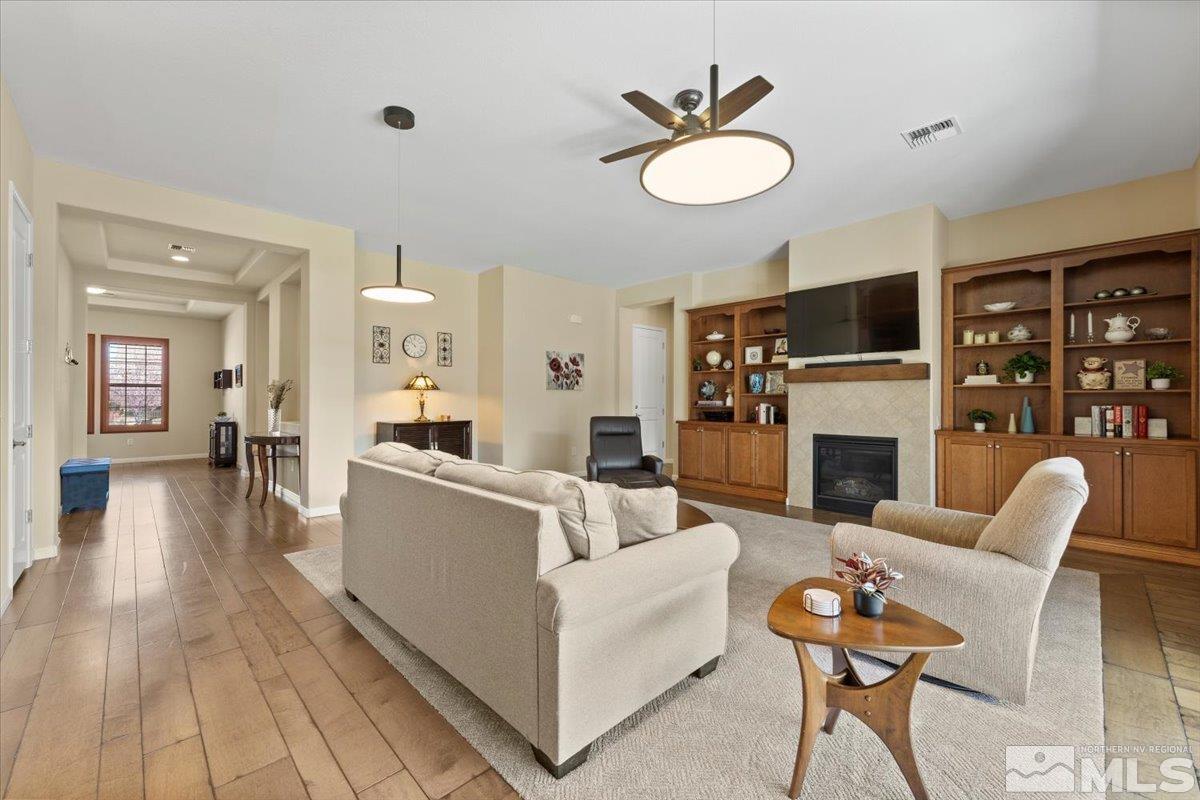 2300 Arpagos Lane Reno, NV 89521 - Photo 8 of 40 a living room with furniture a fireplace and a flat screen tv