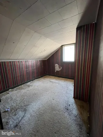 a view of an empty room with wooden walls