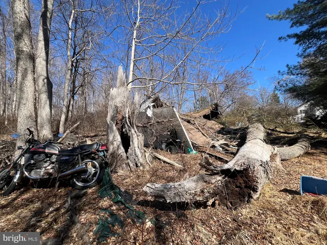 a view of a house with a yard covered in snow