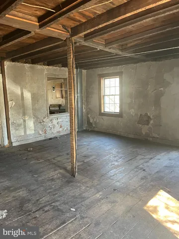 a view of a room with wooden floor and windows
