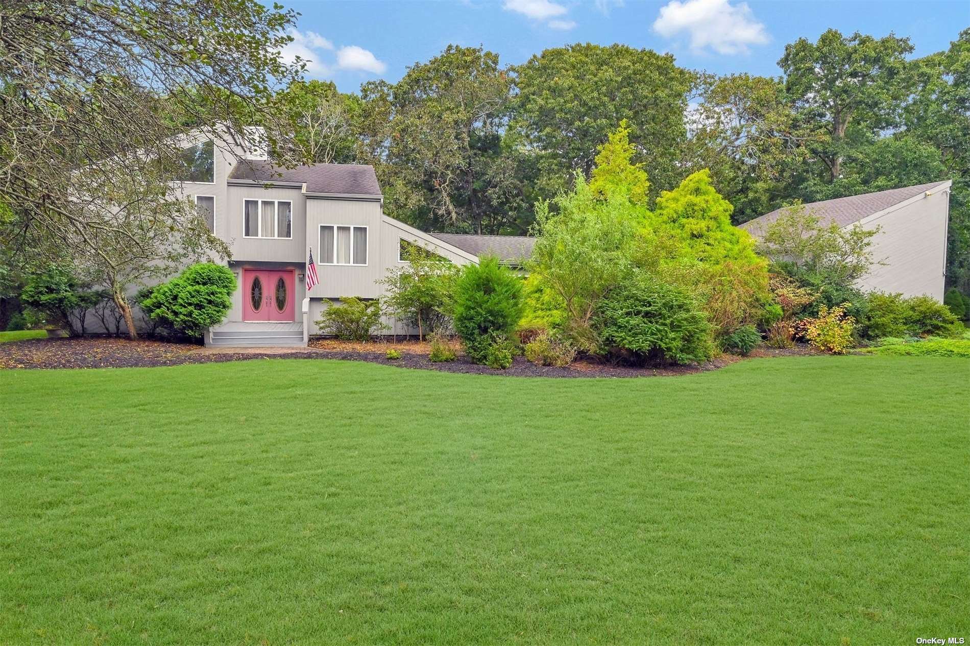 8 Inlet View Path East Moriches, NY 11940 - Photo 1 of 1 a front view of a house with a yard and trees