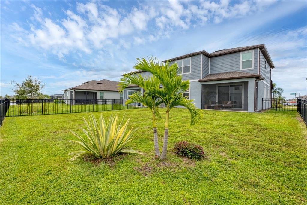 a house view with swimming pool in front of it