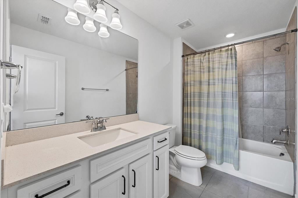 9528 Lamine Way Parrish, FL 34219 - Photo 16 of 58 a bathroom with a sink a toilet and shower