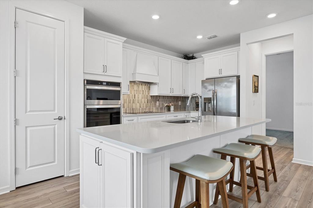9528 Lamine Way Parrish, FL 34219 - Photo 23 of 58 a kitchen with stainless steel appliances a refrigerator and a stove top oven