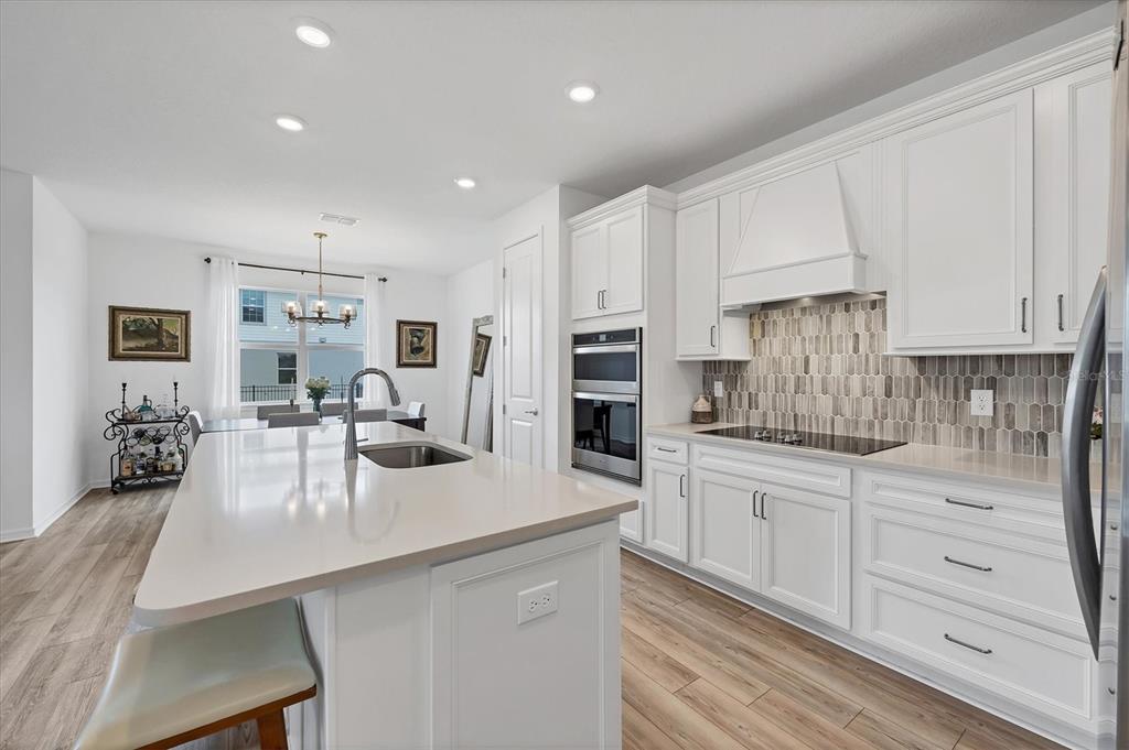 9528 Lamine Way Parrish, FL 34219 - Photo 3 of 58 a kitchen with white cabinets and counter space