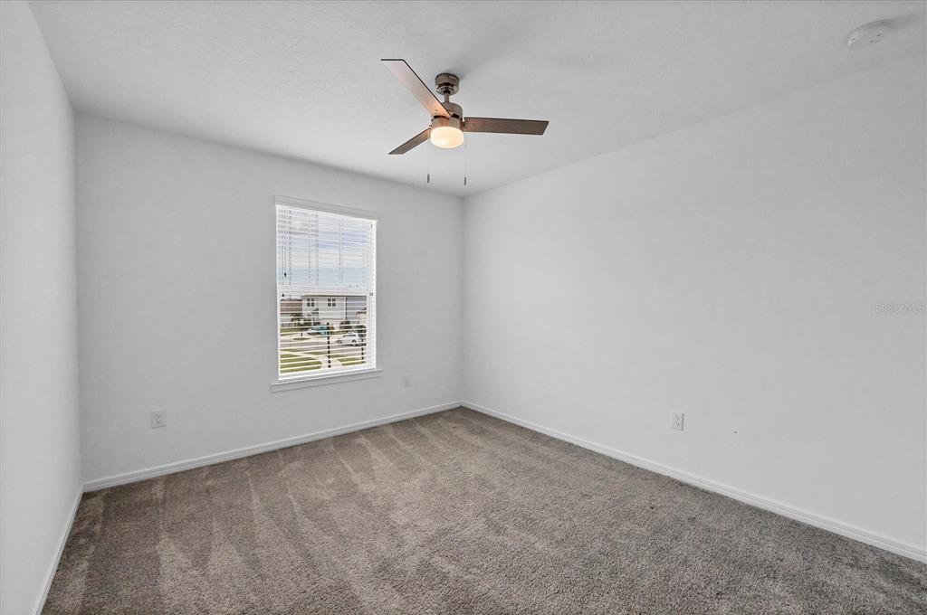 9528 Lamine Way Parrish, FL 34219 - Photo 31 of 58 an empty room with a window and a ceiling fan